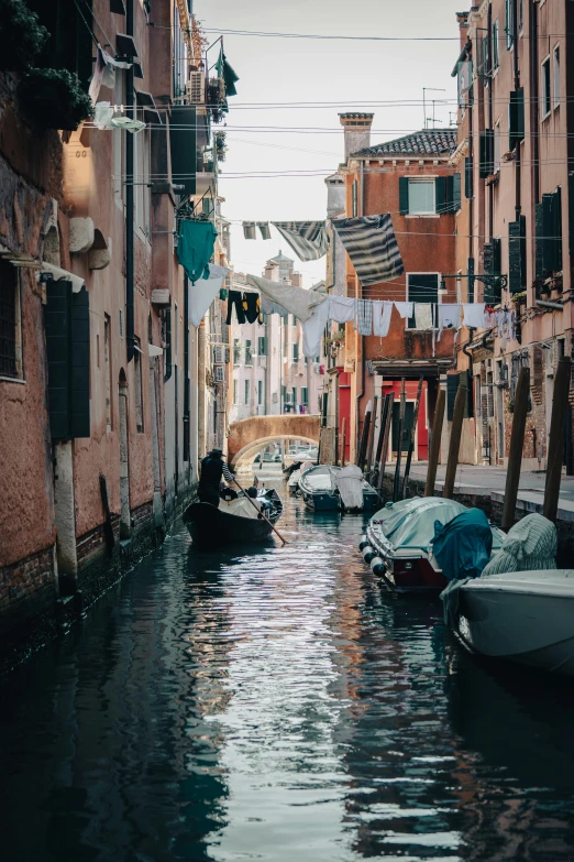 a city street with buildings and a boat in the middle