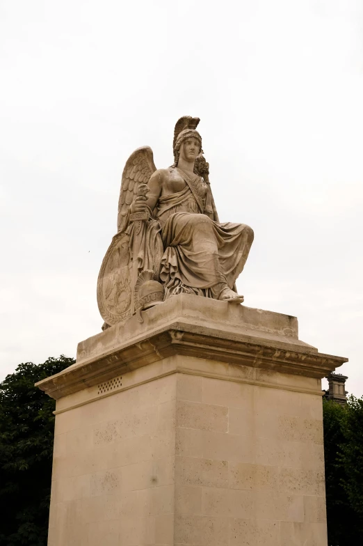 a statue sitting on top of a tall pedestal