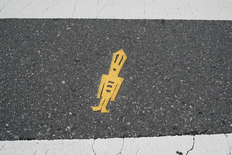 the pavement is paved with white lines, yellow and black stripes, and is marked with a yellow tape