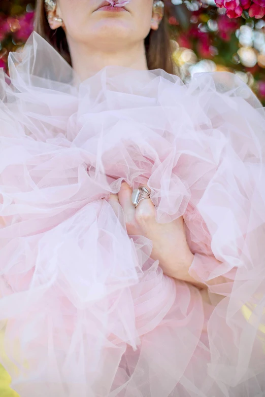 a woman with an embellished nose and pink dress