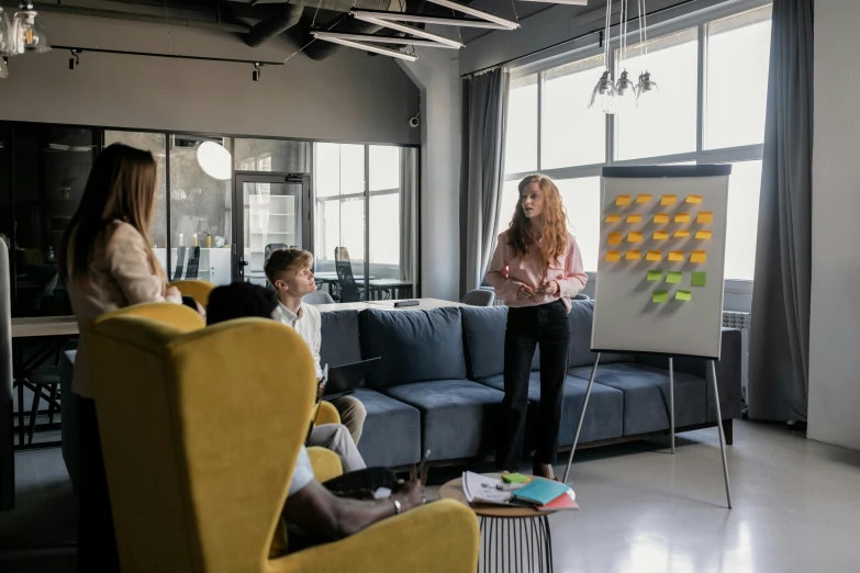 several people are sitting in an office with a poster on the wall