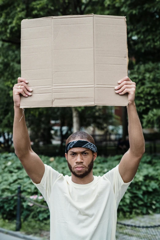 a man holds up a box over his head