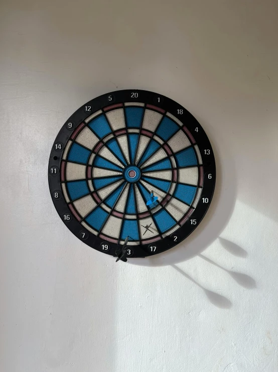 a dart hitting a dart on the wall