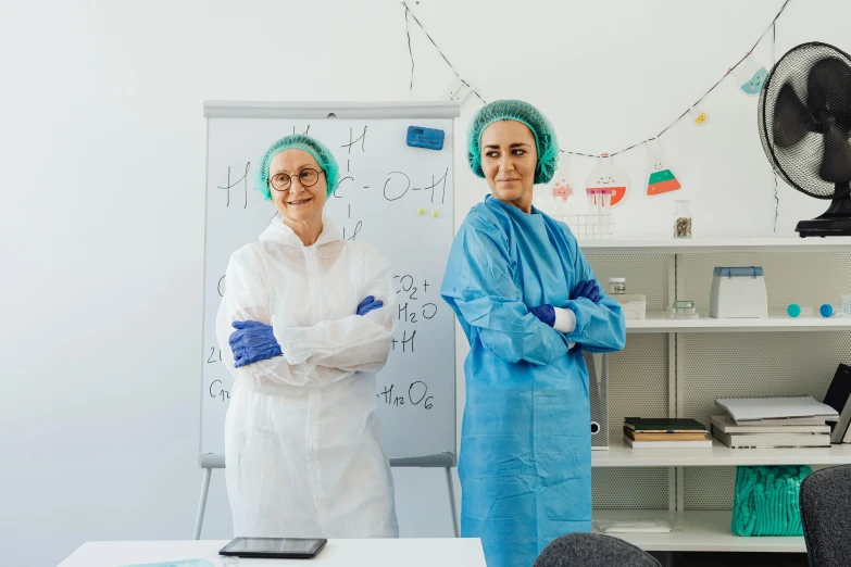 two older people standing in front of a whiteboard with magnets