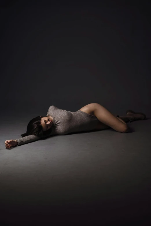 woman lying on floor with head on hand