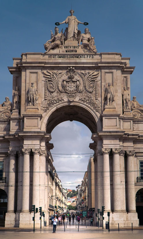 a large stone arch with statues on it