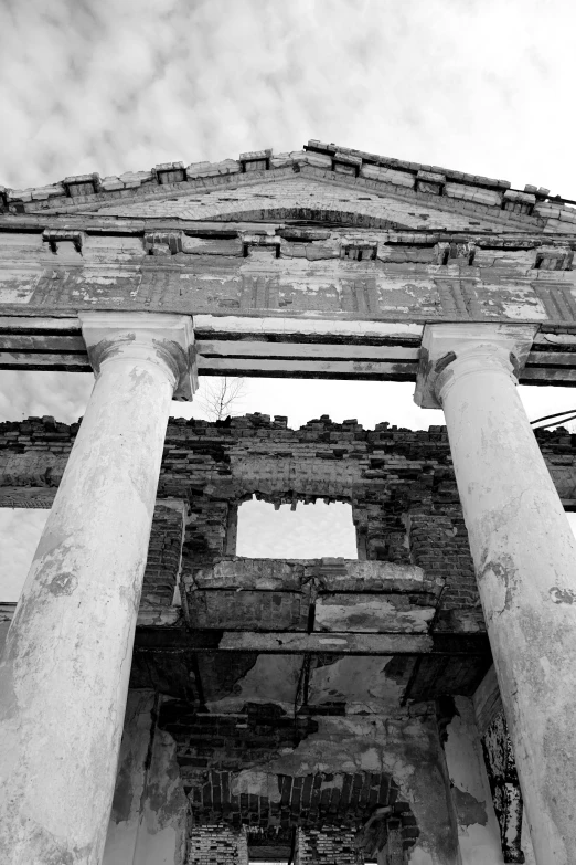 three very tall white stone structures with large pillared pillars