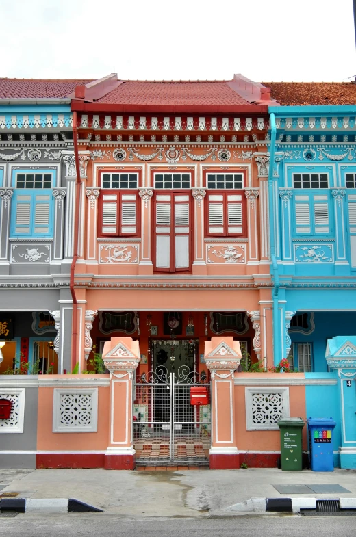 three multi - colored houses have shutters in front of them