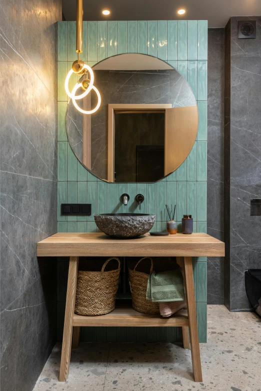 the modern bathroom features a round circular mirror and wooden stool