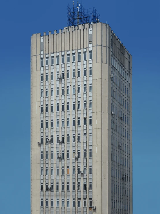 a very tall gray building sitting on top of a hillside