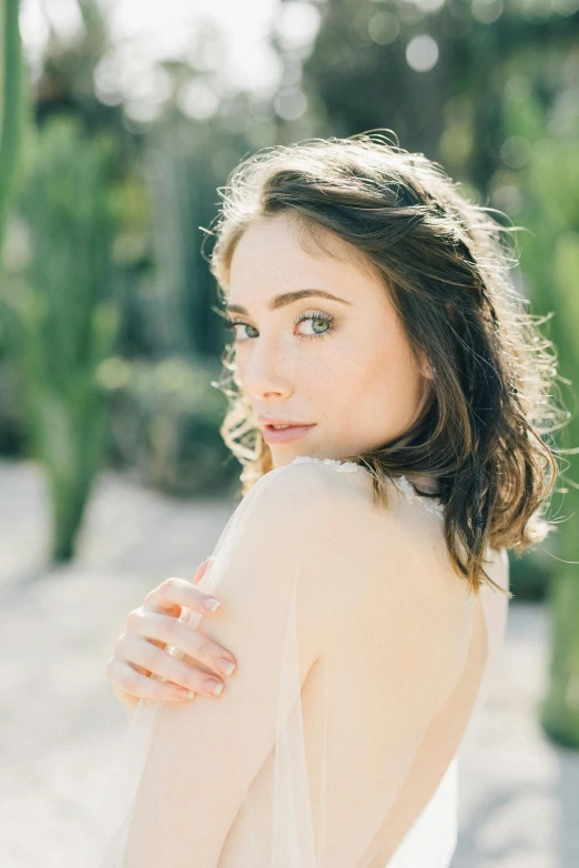 a woman in white is posing for the camera