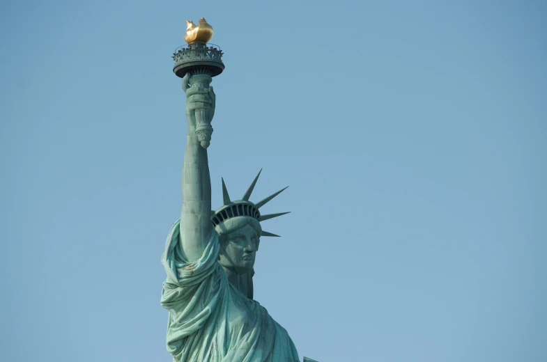 the statue of liberty against a blue sky