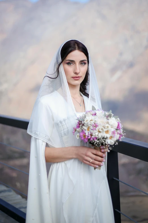 a bride in a wedding dress holding a bouquet