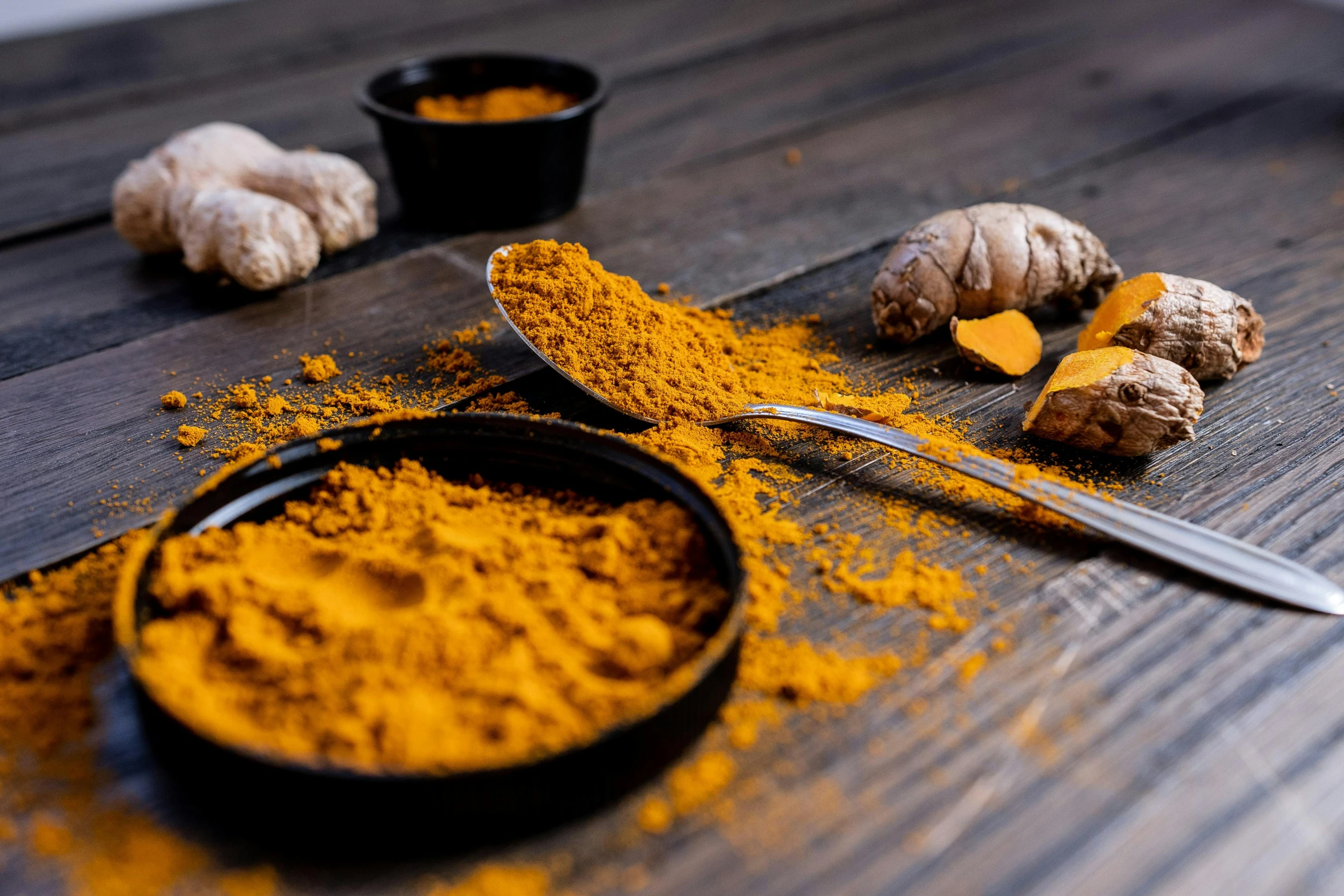 a spoon full of turments is on the table next to some other ingredients