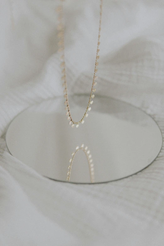 a necklace that is laying on a glass plate