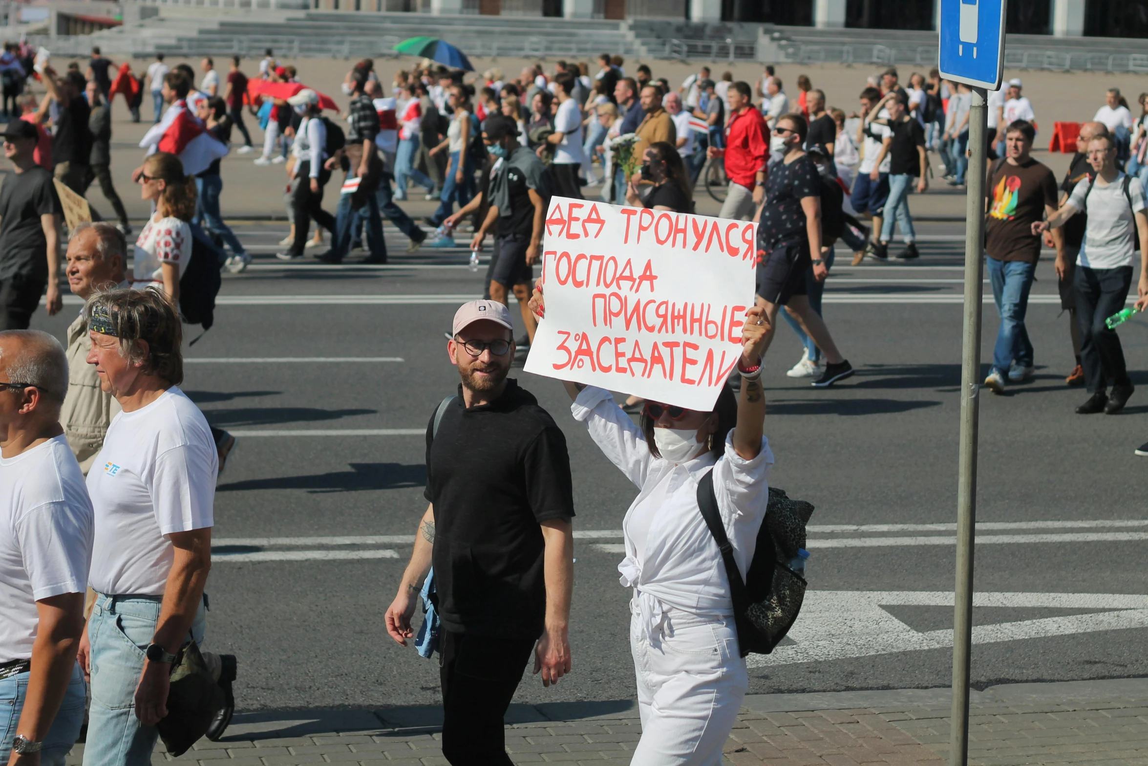 a man holds a sign for an opposing protest