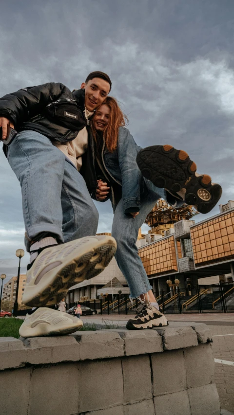 a young man and woman doing stunts on skate boards