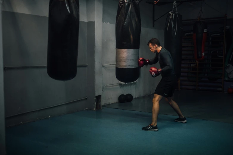 a man practicing boxing with his punching gloves