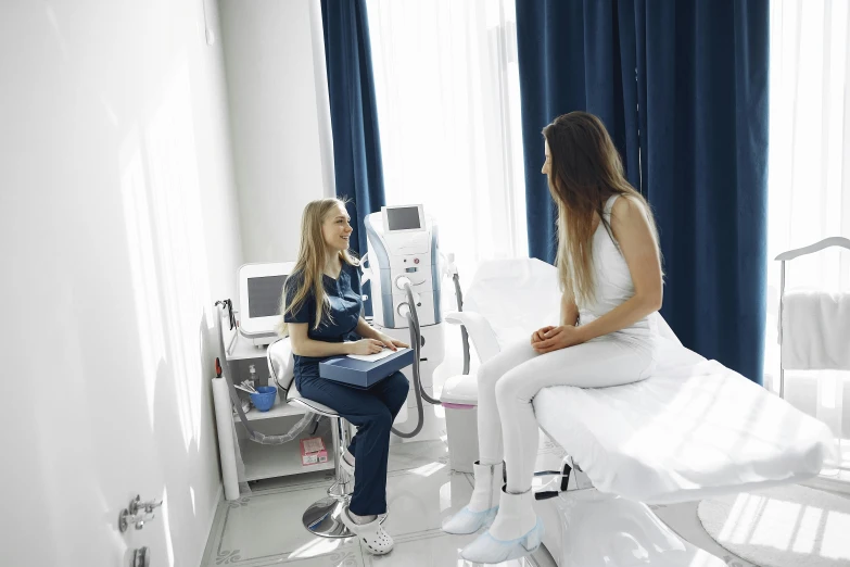 two young women sitting next to each other in hospital