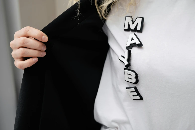 woman holding out a t - shirt to show her name