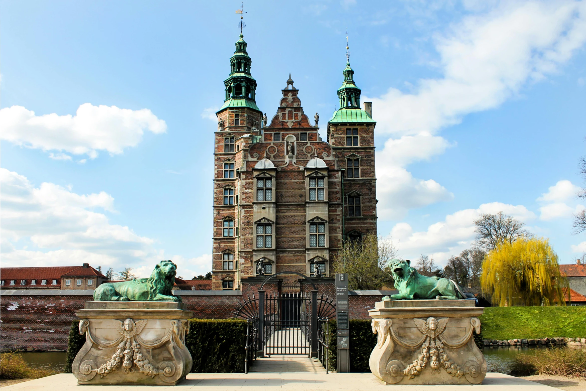 an ornate gate with statues surrounding it