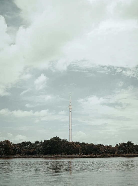 the ocean in front of a radio tower