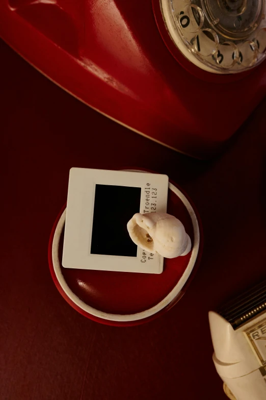 an alarm clock sitting next to an ipod on a table