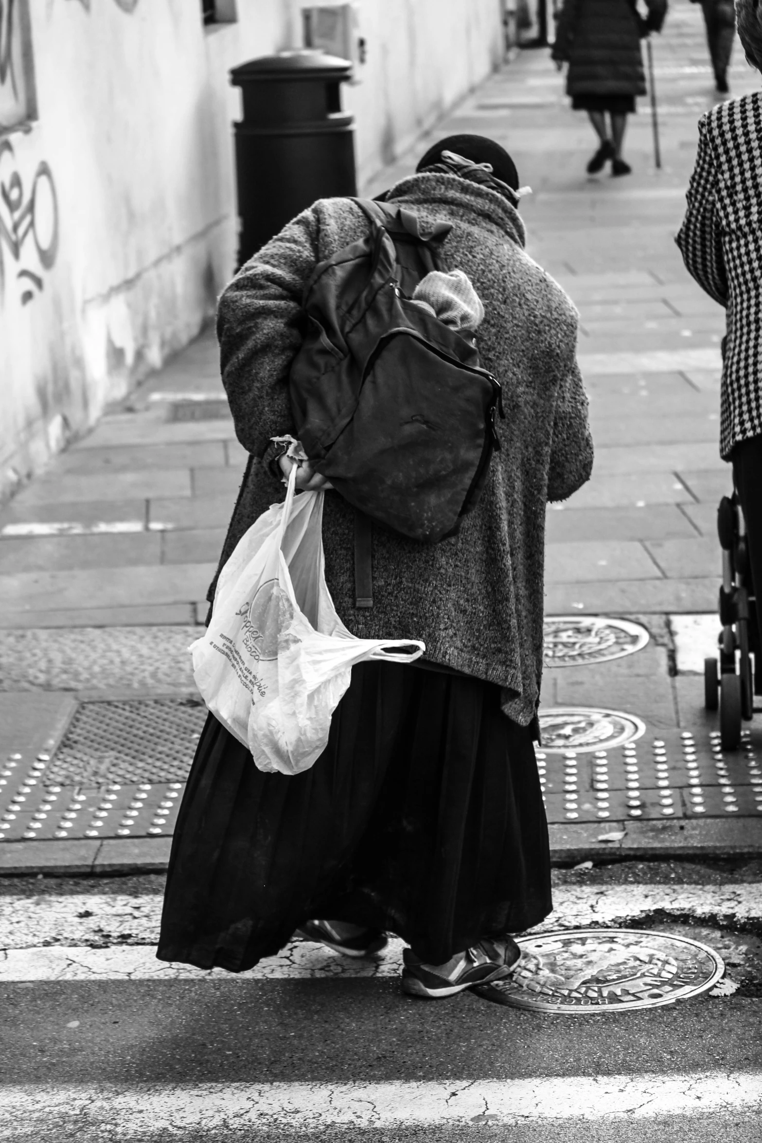 a woman is leaning on a wall and holding her head