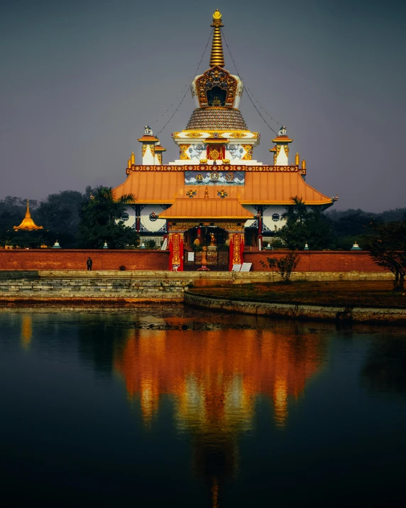 an image of a temple with water and sky in the background