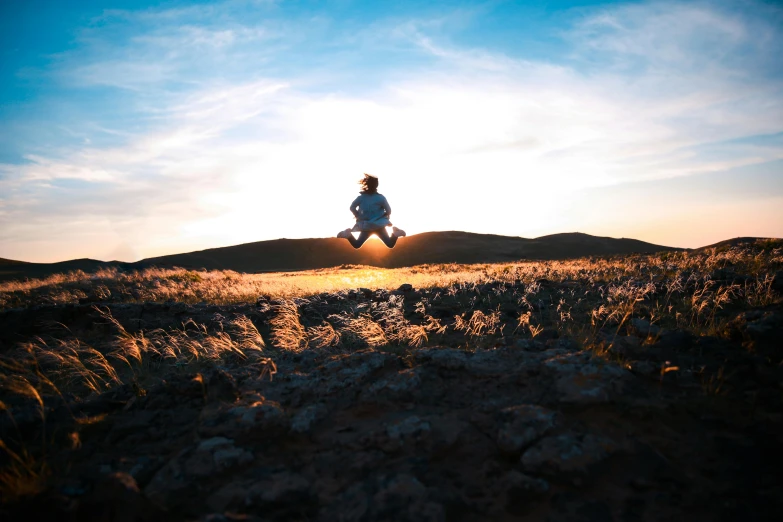 a man running on the grass in the middle of a field