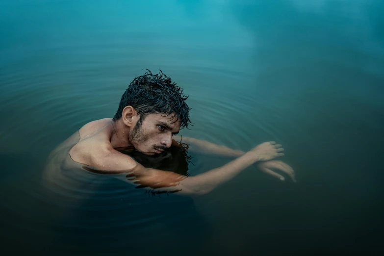 a man floating in the water while wearing 