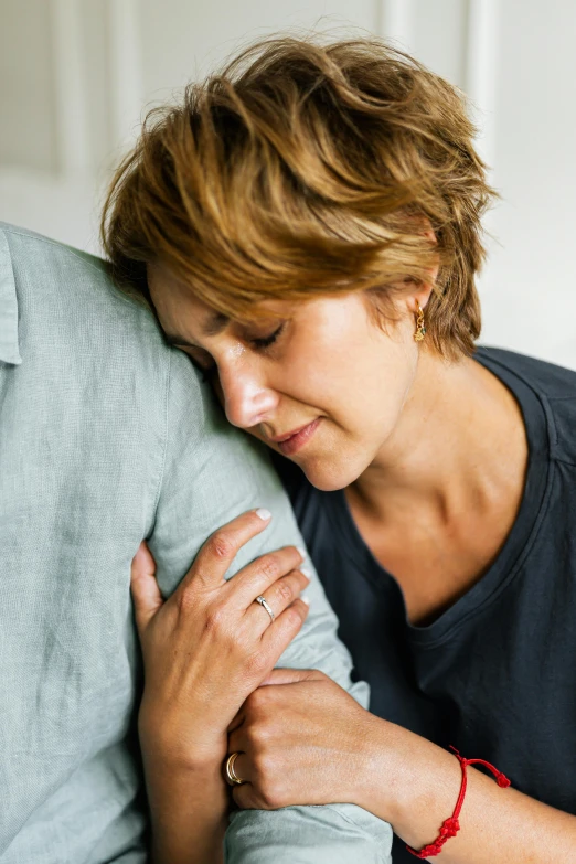 woman holding up the arm of a large couch