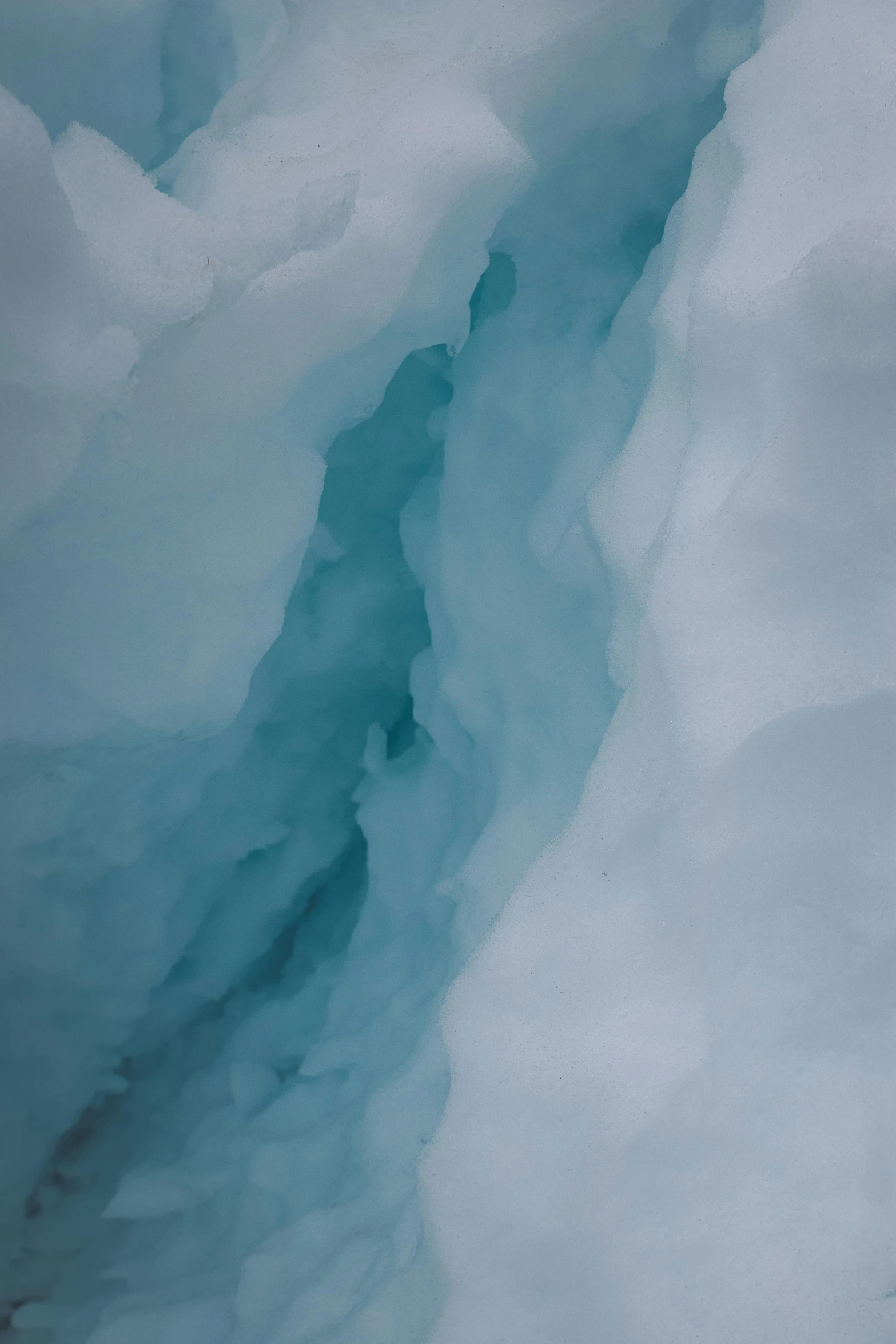 a close up of a mountain with some blue water