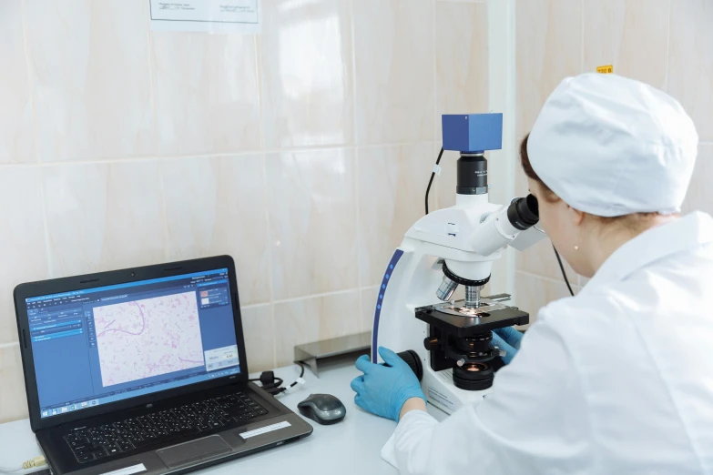 a scientist looking at soing on a laptop