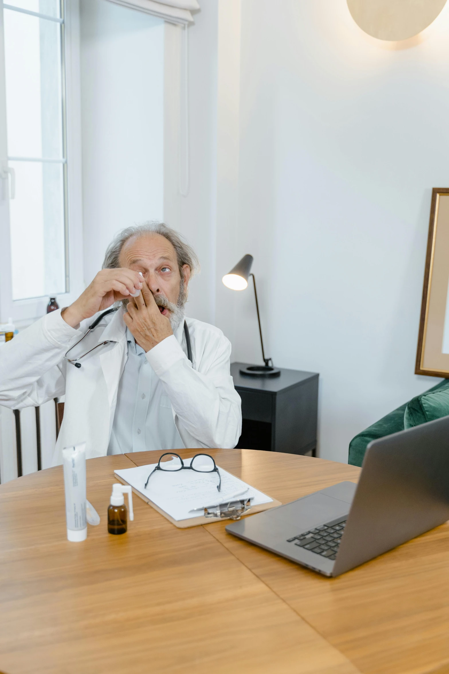 an old man that is sitting in front of a laptop