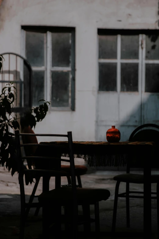 a dark and shadowy table sitting in the sun