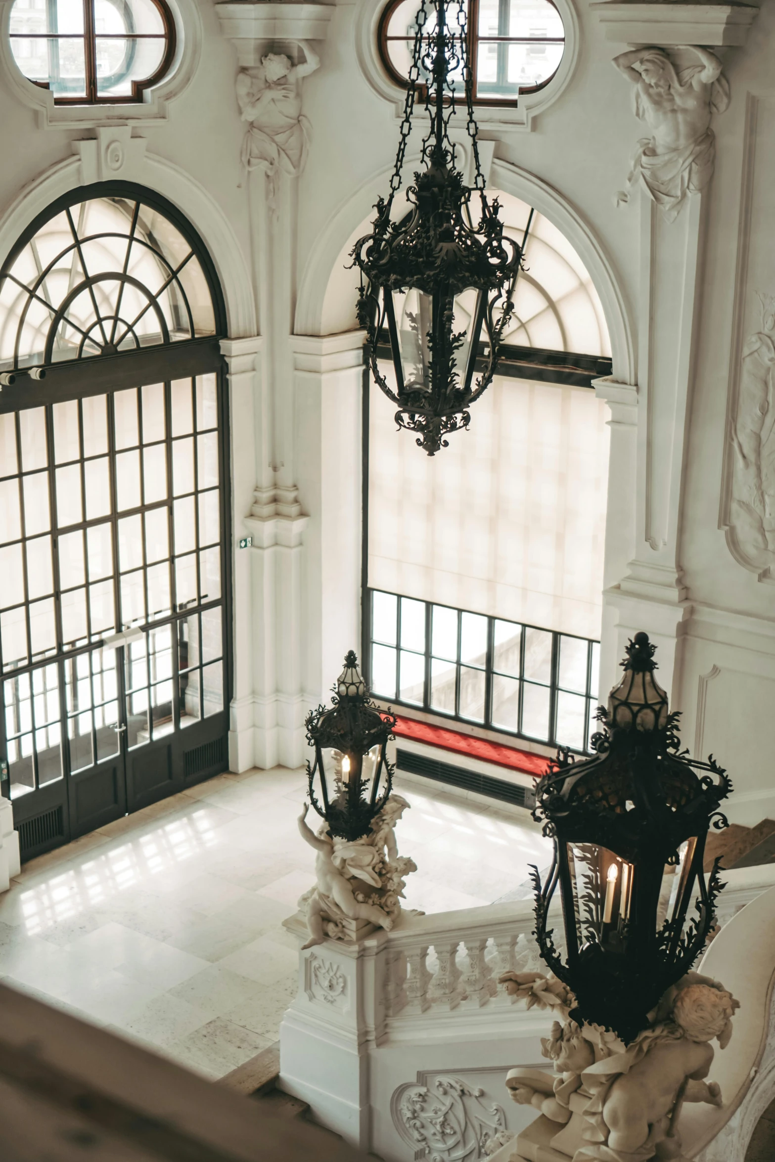 an elegant setting with white marble stairs and ornate windows