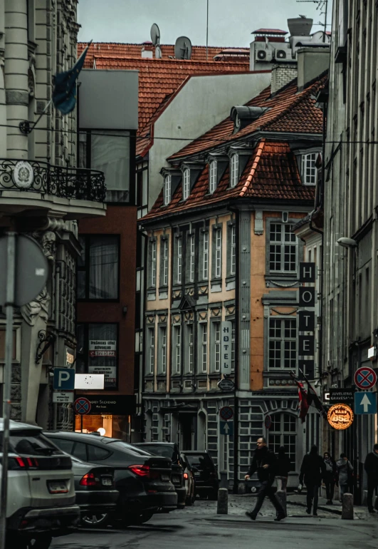 a group of people walking down a street in a city