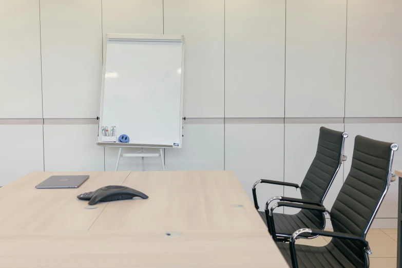 a computer mouse is sitting on a conference room table