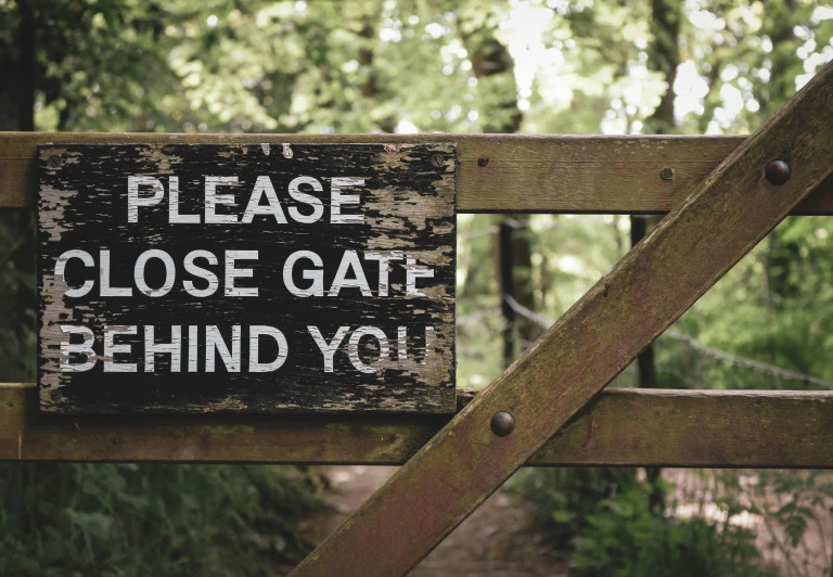 a wooden sign stating that someone is closed