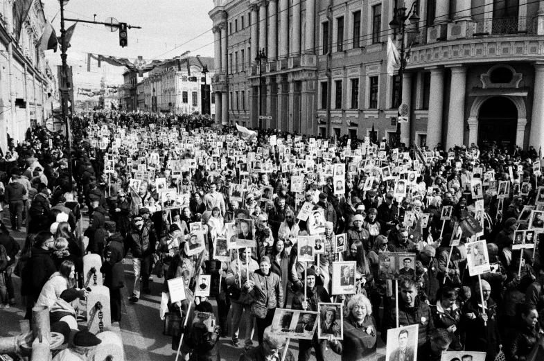 an extremely large crowd of people stand together