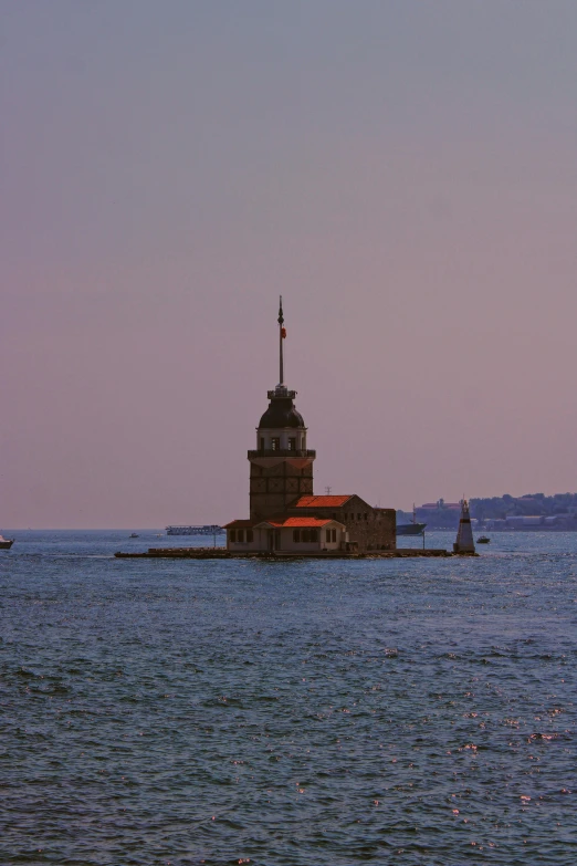 there is a boat on the water with a small building on it