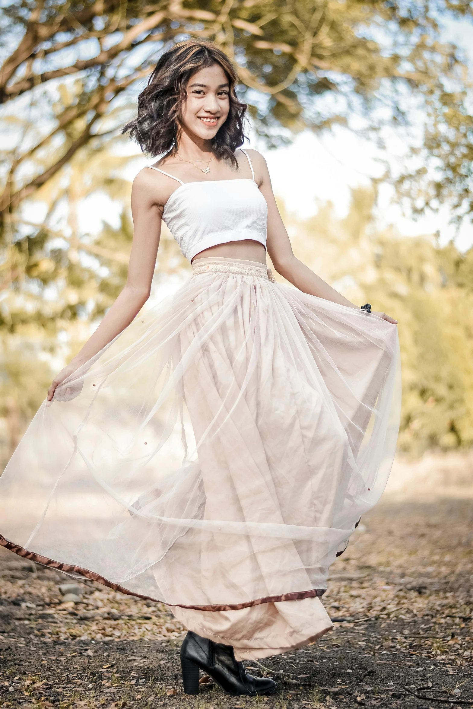 a woman wearing a skirt in the woods