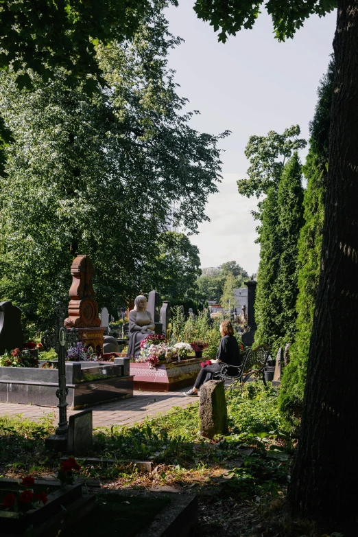 people gather to sit and talk at a cemetery