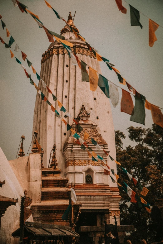 a church building sitting next to tall flags