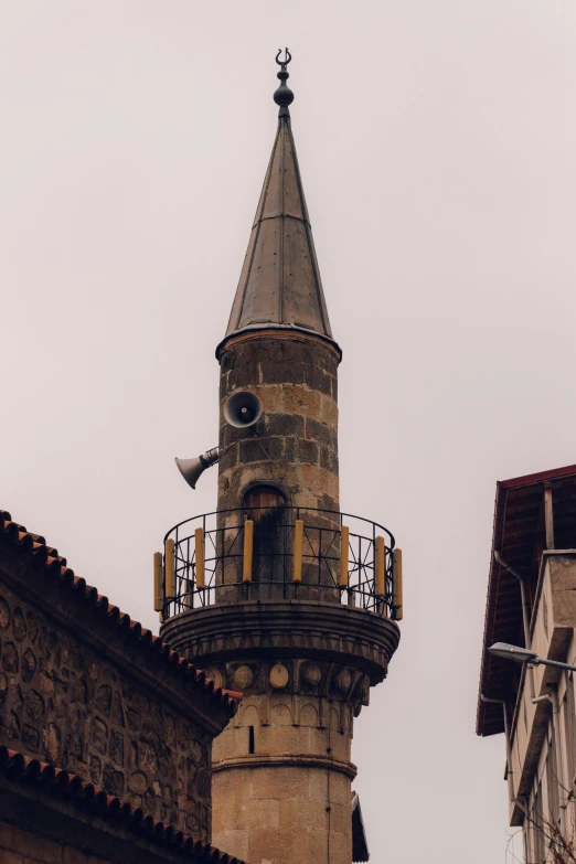 the clock tower is located near two buildings