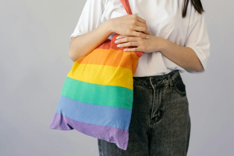 a woman holding a rainbow colored towel