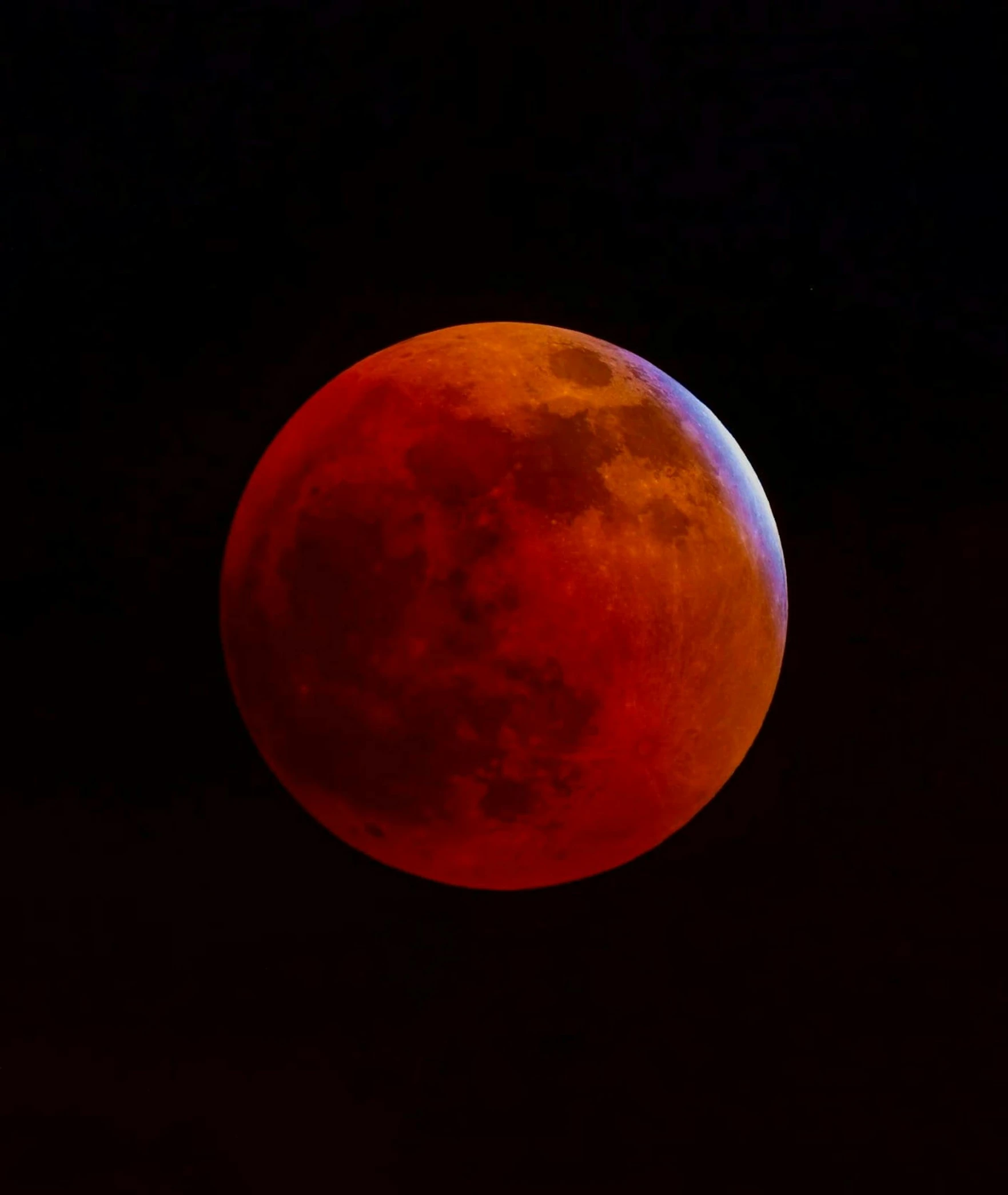 a  moon seen in the night sky from near dawn