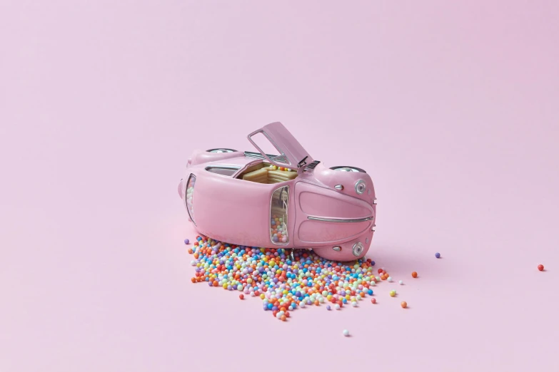a pink purse is lying on top of some confetti
