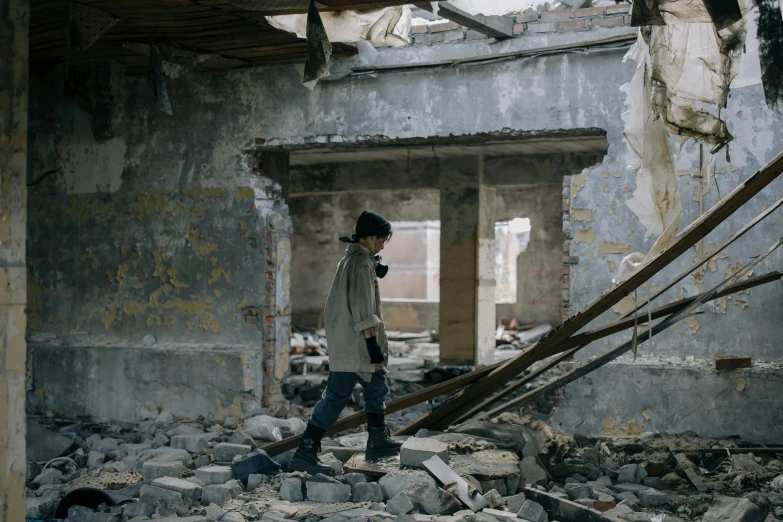 a man in the midst of a construction project, walking in rubble